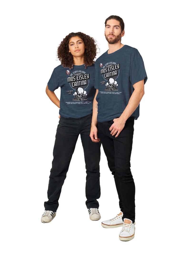 May include: Two people wearing navy blue t-shirts with the text "Mos Eisley Cantina" and a graphic of three alien heads. The shirts are paired with black jeans and white sneakers. The text also includes "Featuring Lux" and other text.