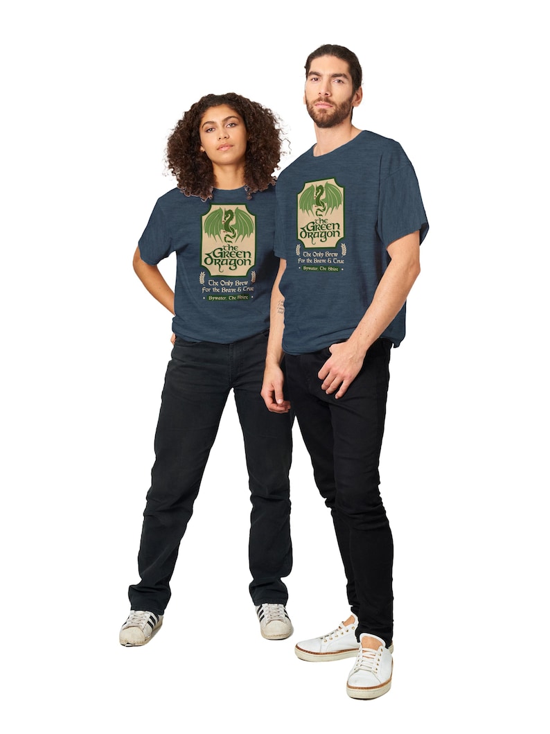 May include: Two people wearing blue heather t-shirts with a green dragon graphic and the text "The Green Dragon" and "The Only Brew for the Brave & True".
