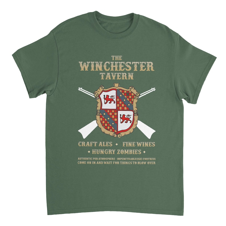 May include: A green t-shirt with a vintage-style graphic of a coat of arms and the text "The Winchester Tavern." The graphic also includes crossed rifles and the text "Craft Ales, Fine Wines, Hungry Zombies." The text below the graphic reads "Authentic Pub Atmosphere - Impenetrable(ish) Fortress. Come on in and wait for things to blow over."