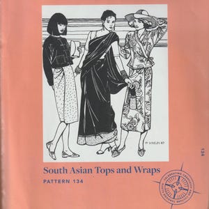 May include: A sewing pattern booklet featuring three women wearing South Asian tops and wraps. The cover is peach colored with the title "Folkwear patterns with timeless style" and the pattern number "134" printed on it. The text "South Asian Tops and Wraps" is printed in blue below the illustration.