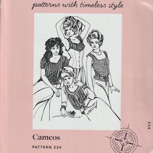 May include: A pink Folkwear pattern envelope featuring a black and white illustration of four women in vintage clothing. The text "FOLKWEAR patterns with timeless style" and "Cameos PATTERN 234" are also visible.