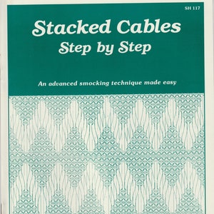 May include: A book titled "Stacked Cables Step by Step" with a green cover and a white illustration of a smocking pattern. The book is by Saudy Hunter and is an advanced smocking technique made easy.