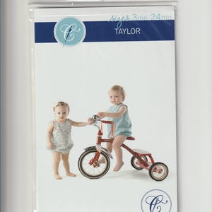 May include: A sewing pattern package featuring two babies, one on a red tricycle and the other standing beside it. The package has text that reads "Sizes 3mo-24mo" and "TAYLOR". The brand name "children's corner PATTERNS" is also visible.