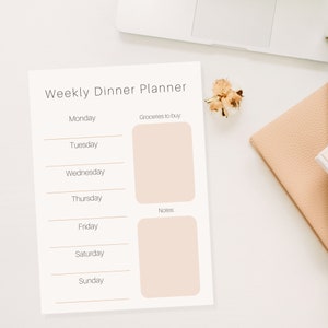 May include: A printable weekly dinner planner with a white background and brown lines. The planner includes sections for each day of the week, a section for groceries to buy, and a section for notes.
