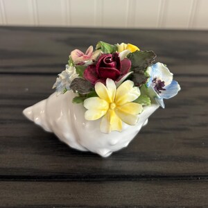 May include: A set of three ceramic nesting bowls in shades of blue, green, and white. The bowls feature a speckled glaze and a simple, modern design. Each bowl is a different size, with the largest measuring approximately 6 inches in diameter.