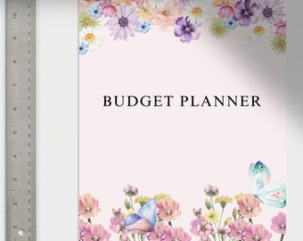 May include: A pink and white budget planner with a floral design and butterflies. The cover features the text "BUDGET PLANNER".