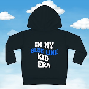May include: Black hooded sweatshirt with the text "In My Blue Line Kid Era" in white and blue lettering.