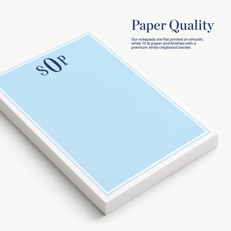 a set of white notepads with a blue border, arranged on a white surface.