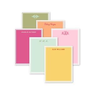 May include: Five different colored notepads with personalized names and monograms. The notepads are in shades of pink, green, orange, yellow, and light pink.