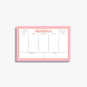 The image is a pink and white calendar or schedule organizer with the word "GEORGIA" prominently displayed. It appears to be a simple, functional design with a grid layout for organizing days and events.