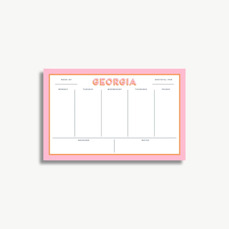The image is a pink and white calendar or schedule organizer with the word "GEORGIA" prominently displayed. It appears to be a simple, functional design with a grid layout for organizing days and events.