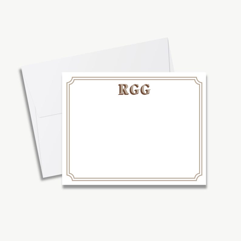 a blank card with a decorative border, placed on top of an envelope.