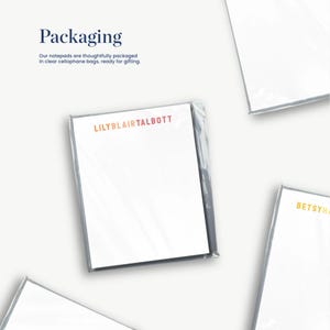 several white pieces of paper or cards, each with a different color or design, arranged in a collage-like manner.