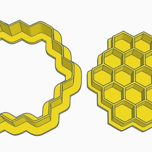 May include: Two yellow plastic cookie cutters. One is a wavy-edged circle, and the other is a honeycomb shape. These cutters are likely used for baking cookies or other treats with a bee or honey theme.