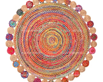 May include: Round jute rug with a multi-colored woven design and a fringe border of colorful pom-poms.