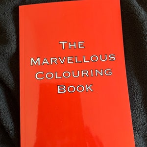 May include: A red book with the title "THE MARVELLOUS COLOURING BOOK" printed in white.