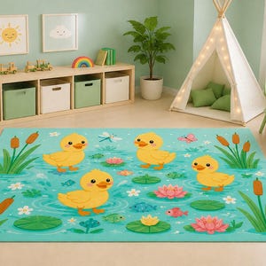 May include: A rectangular area rug featuring a light teal background with a pattern of three yellow ducklings swimming in a pond. The design includes green lily pads, pink lotus flowers, brown cattails, small blue fish, and a dragonfly.