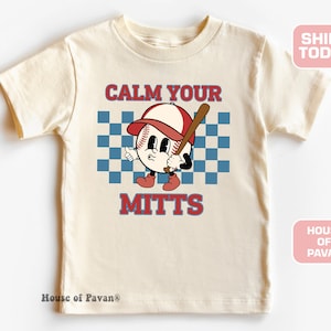 May include: A cream colored t-shirt with a cartoon baseball character holding a bat. The text "Calm Your Mitts" is printed on the shirt.