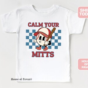 May include: White t-shirt with a red, white, and blue baseball graphic and the text "Calm Your Mitts".