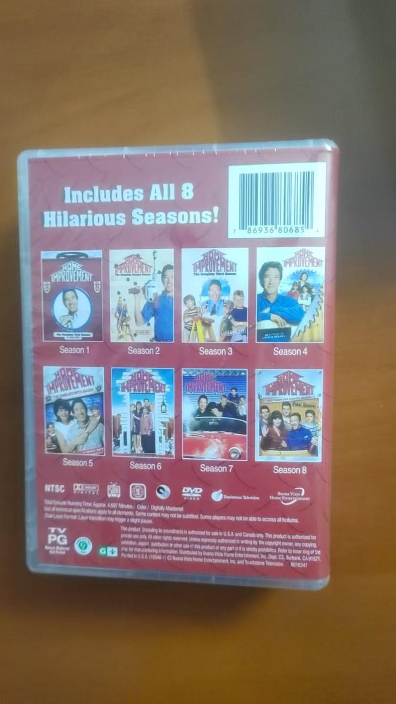 May include: DVD set of the TV show "Home Improvement", featuring all eight seasons. The packaging is red with images from the show's episodes. The text "Includes All 8 Hilarious Seasons!" is visible.