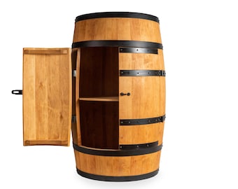 May include: A wooden barrel cabinet with a door that opens to reveal two shelves. The cabinet is made of natural wood and has black metal accents.