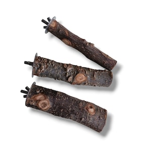 May include: Three brown wooden bird perches with metal attachments. The perches are different lengths and have a natural bark texture.