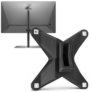 以下が含まれることがあります： 黒いX字型のモニター台。表面はテクスチャ加工が施され、4つの取り付け穴があります。グレーのコンピューターモニターの前に配置されています。