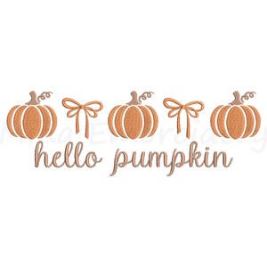 May include: An embroidered design featuring four orange pumpkins with brown stems and a bow between the first two pumpkins. The phrase "hello pumpkin" is written in a cursive font below the pumpkins. The design is on a white background.