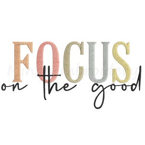 May include: White background with the embroidered text "FOCUS on the good." The word "FOCUS" is in a mix of colors: peach, pink, gold, silver, and yellow. The words "on the" and "good" are in a black script font.