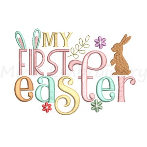 以下が含まれることがあります： 「My First Easter」の文字と、ウサギ、花、葉が描かれたカラフルな刺繍デザインです。
