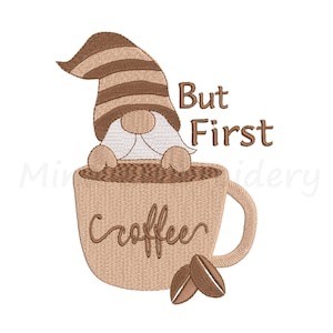 May include: Embroidered design of a gnome sitting in a coffee mug with the text "But First Coffee".