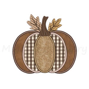 May include: An embroidered pumpkin design featuring alternating sections of solid brown fabric, brown and white gingham check fabric, and a central textured tan panel. The pumpkin has a dark brown stem and two light brown oak leaves.