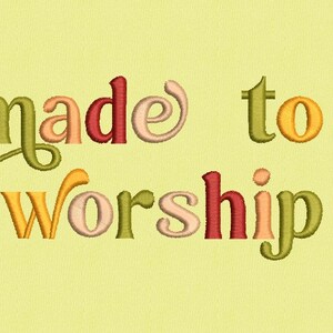 May include: Made to Worship text in a colorful, embroidered font. The letters are in shades of green, yellow, orange, and red.