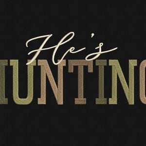 May include: Black background with the words "He's HUNTING" in a decorative font. The word "He's" is in a cursive white font, while "HUNTING" is in a block letter style with a camouflage pattern.