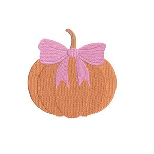 May include: An embroidered pumpkin with a pink bow. The pumpkin is orange with a brown stem. The bow is a light pink colour. The design is on a white background.