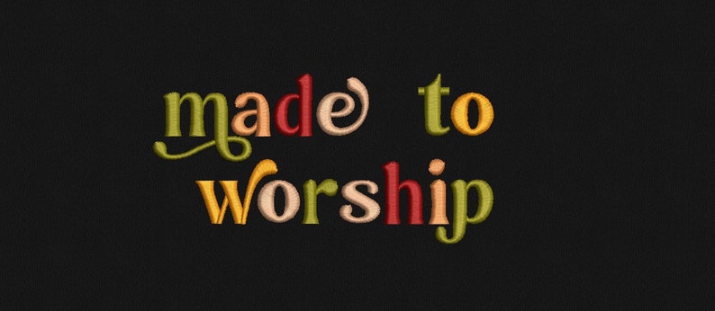 May include: Embroidered text on a black background that reads "made to worship" in colorful, stylized lettering.