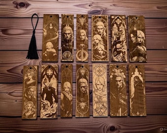 May include: A collection of wooden bookmarks with engraved character portraits and designs. The bookmarks feature detailed illustrations of figures, with a black tassel attached to one. The wood has a warm, natural tone.