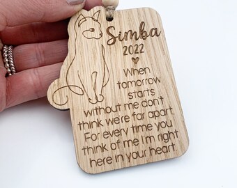 May include: Wooden ornament with a cat silhouette and the text "Simba 2022" and a message about remembering a loved one.  "When tomorrow starts without me don't think we're far apart. For every time you think of me I'm right here in your heart."
