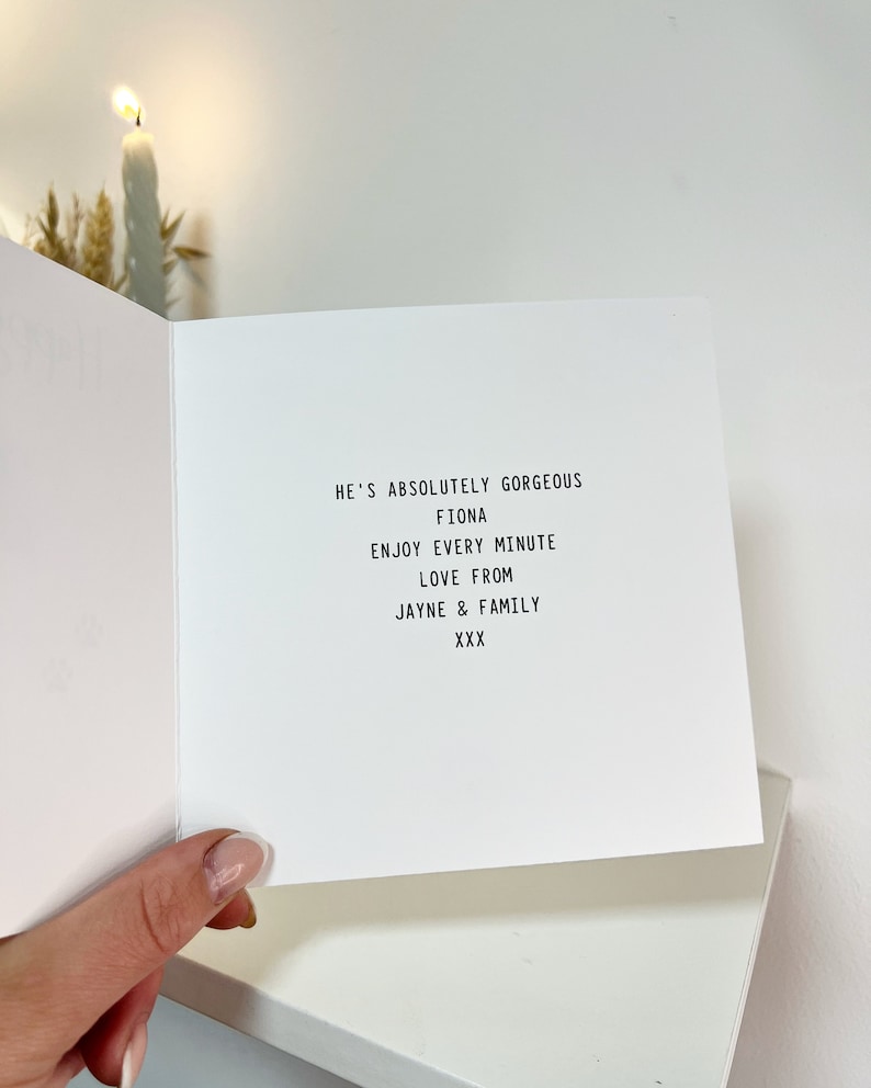 May include: A white card with black text that reads "He's absolutely gorgeous Fiona Enjoy every minute Love from Jayne & Family XXX"