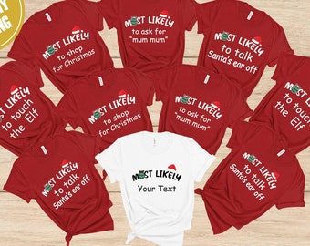 May include: A collection of red and white t-shirts with Christmas-themed text. The shirts feature phrases like "Most Likely to shop for Christmas" and "Most Likely to touch the Elf." The shirts have a Santa hat graphic.