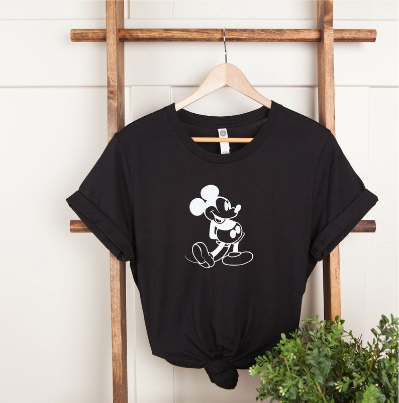 May include: Black t-shirt with a white silhouette of Mickey Mouse.