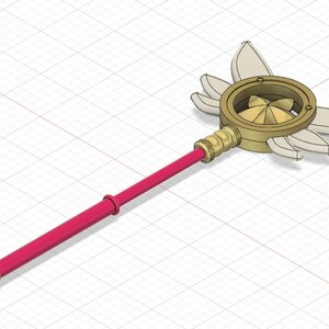 Könnte beinhalten: Ein goldener Zauberstab mit einem runden, fächerförmigen Kopf und fünf weißen Flügeln. Der Zauberstab hat einen roten Griff.