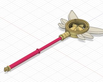 Op de afbeelding: Een gouden toverstaf met een ronde, waaiervormige kop en vijf witte vleugels. De toverstaf heeft een rode handvat.