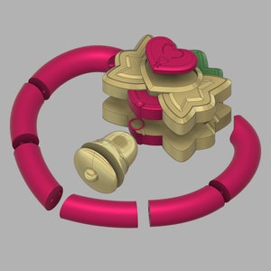 May include: A pink and gold toy with a bell and a heart-shaped charm. The toy is made of plastic and is designed to be a rattle.