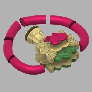 May include: A gold, green, and red Christmas ornament with a bell, a heart, and a star design. The ornament is made of multiple pieces that can be assembled together.