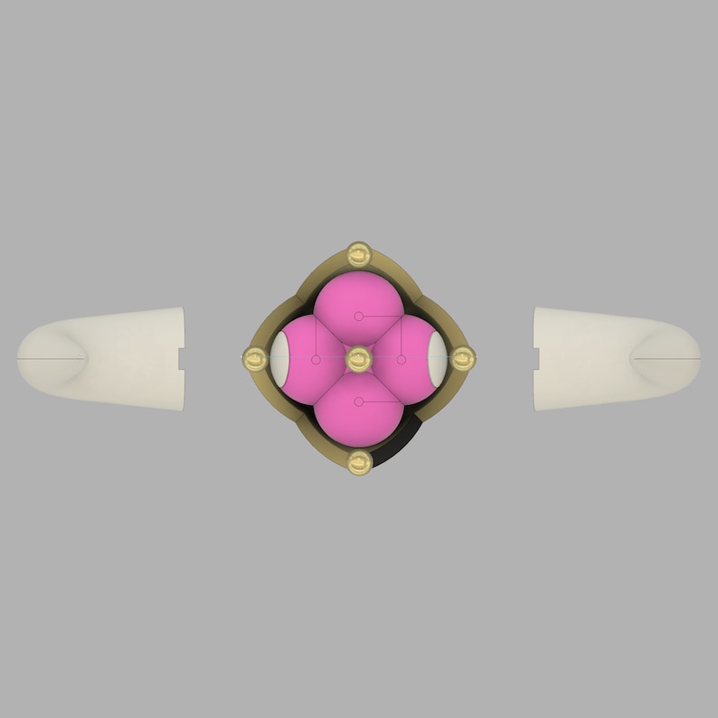 K&ouml;nnte beinhalten: Ein goldfarbenes Dekorationsst&uuml;ck mit vier rosafarbenen Kugeln in der Mitte. Das St&uuml;ck hat ein geometrisches Design mit vier Punkten.