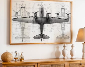 May include: A framed vintage airplane blueprint art print. The print features detailed technical drawings of a multi-engine aircraft, showcasing top, front, and side views. The artwork is in grayscale, set against a cream-colored background, and framed in a natural wood.