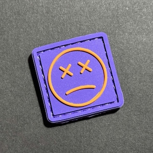 PVC-moraalpatch Sad Mood Face, paarsgeel Ranger Eye (1 x 1 inch)