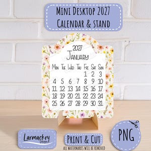 May include: A 2027 mini desktop calendar and stand featuring a floral pattern with pink, yellow, and purple wildflowers. The calendar displays the month of January with the days of the week and dates. Text includes Mini Desktop 2027 Calendar & Stand, Print & Cut, and PNG.