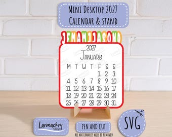 May include: A 2027 mini desktop calendar and stand featuring a white card with black text for January, a red border, and a colorful monthly tab header. Includes small labels with the text Mini Desktop 2027 Calendar & Stand, Larmackry Designs, and SVG.